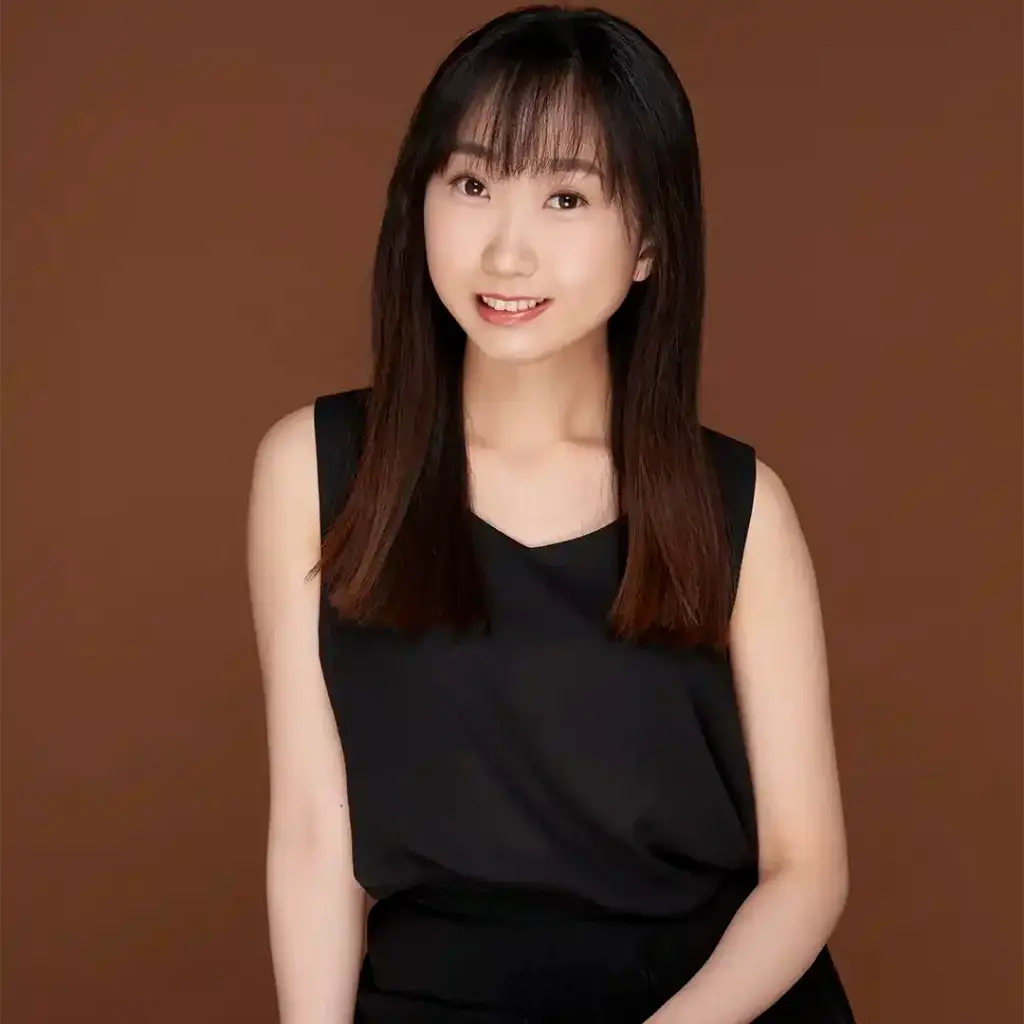 Young Asian woman against dark background.
